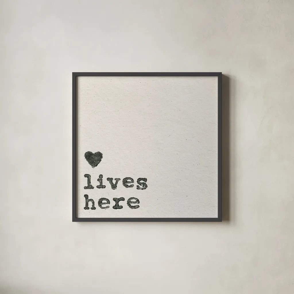 Love Lives Here by Wild Apple Portfolio. Shown in a sleek black glass frame for a contemporary gallery look. Available as an archival giclee rolled canvas, fine art paper, or poster print. SKU 71691a.