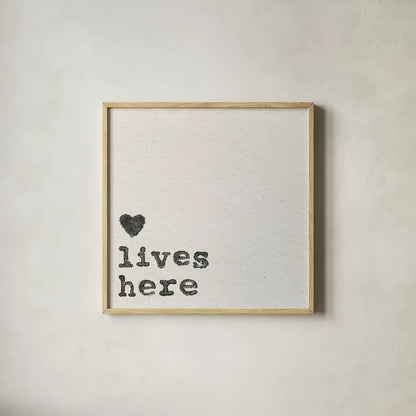 Love Lives Here by Wild Apple Portfolio. Shown in a natural wood glass frame for a timeless modern aesthetic. Available as an archival giclee rolled canvas, fine art paper, or poster print. SKU 71691a.