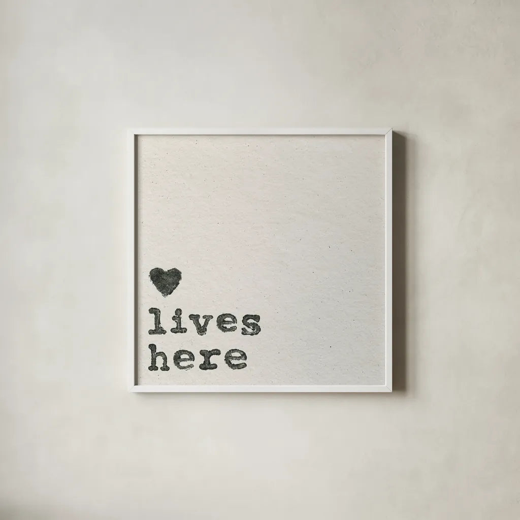 Love Lives Here by Wild Apple Portfolio. Shown in a crisp white glass frame for a clean and minimalist style. Available as an archival giclee rolled canvas, fine art paper, or poster print. SKU 71691a.