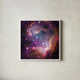 Magellanic Cloud Galaxy by Wild Apple Portfolio. Shown in a crisp white glass frame for a clean and minimalist style. Available as an archival giclee rolled canvas, fine art paper, or poster print. SKU 89316a.