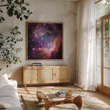 Magellanic Cloud Galaxy by Wild Apple Portfolio. Shown in a natural wood frame in a cozy modern living room. Available as an archival giclee rolled canvas, fine art paper, or poster print. SKU 89316a.
