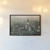 Manhattan at Night by Wild Apple Portfolio. shown as a paper print in a black flame. Available as a archival giclee rolled canvas, fine art paper, or poster print. SKU 46627i.