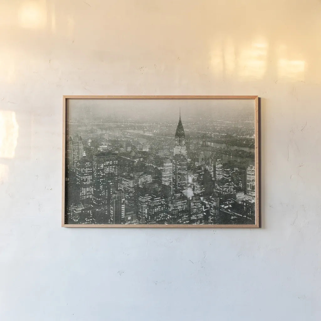 Manhattan at Night by Wild Apple Portfolio. shown as a paper print in a natural frame. Available as a archival giclee rolled canvas, fine art paper, or poster print. SKU 46627i.