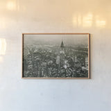 Manhattan at Night by Wild Apple Portfolio. shown as a paper print in a natural frame. Available as a archival giclee rolled canvas, fine art paper, or poster print. SKU 46627i.