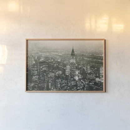 Manhattan at Night by Wild Apple Portfolio. shown as a paper print in a natural frame. Available as a archival giclee rolled canvas, fine art paper, or poster print. SKU 46627i.