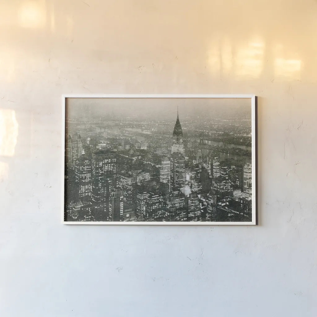 Manhattan at Night by Wild Apple Portfolio. shown as a paper print in a white frame. Available as a archival giclee rolled canvas, fine art paper, or poster print. SKU 46627i.