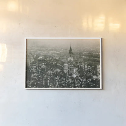 Manhattan at Night by Wild Apple Portfolio. shown as a paper print in a white frame. Available as a archival giclee rolled canvas, fine art paper, or poster print. SKU 46627i.