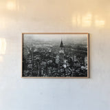 Manhattan at Night Rich Black by Wild Apple Portfolio. shown as a paper print in a natural frame. Available as a archival giclee rolled canvas, fine art paper, or poster print. SKU 64605i.