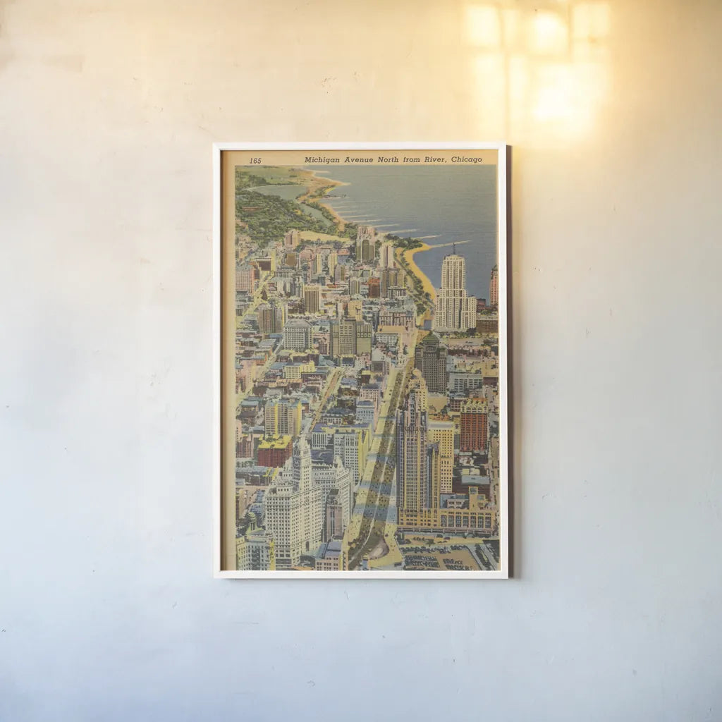 Michigan Avenue North from River Chicago by Wild Apple Portfolio. shown as a paper print in a white frame. Available as a archival giclee rolled canvas, fine art paper, or poster print. SKU 68512h.