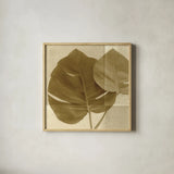 Monstera Leaf II by Wild Apple Portfolio. Shown in a natural wood glass frame for a timeless modern aesthetic. Available as an archival giclee rolled canvas, fine art paper, or poster print. SKU 37204a.