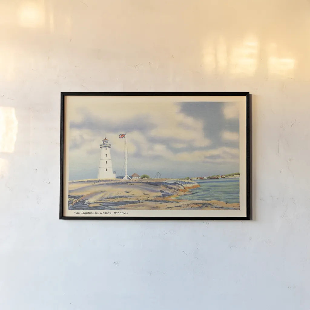 Nassau Lighthouse by Wild Apple Portfolio. shown as a paper print in a black flame. Available as a archival giclee rolled canvas, fine art paper, or poster print. SKU 75652i.