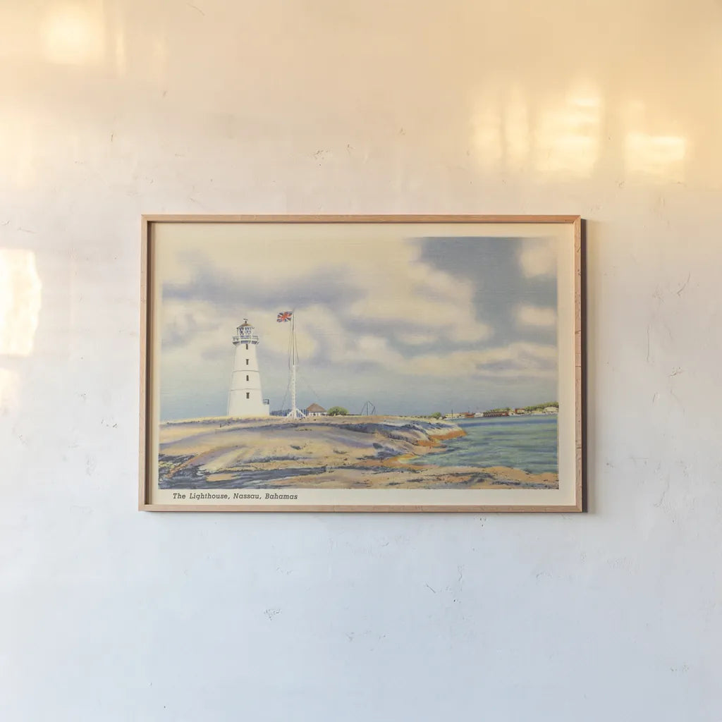 Nassau Lighthouse by Wild Apple Portfolio. shown as a paper print in a natural frame. Available as a archival giclee rolled canvas, fine art paper, or poster print. SKU 75652i.