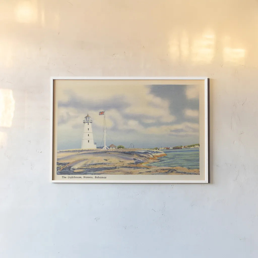 Nassau Lighthouse by Wild Apple Portfolio. shown as a paper print in a white frame. Available as a archival giclee rolled canvas, fine art paper, or poster print. SKU 75652i.