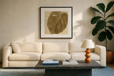 Ornate Monstera Leaf I by Wild Apple Portfolio. Displayed in a glass frame with matte in a clean modern living room. Available as an archival giclee rolled canvas, fine art paper, or poster print. SKU 37203a.