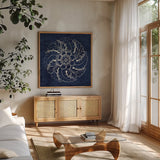Rosette IV Indigo by Wild Apple Portfolio. Shown in a natural wood frame in a cozy modern living room. Available as an archival giclee rolled canvas, fine art paper, or poster print. SKU 23699a.