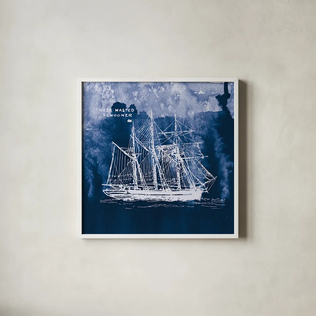 Sailing Ships II Indigo by Wild Apple Portfolio. Shown in a crisp white glass frame for a clean and minimalist style. Available as an archival giclee rolled canvas, fine art paper, or poster print. SKU 32099a.