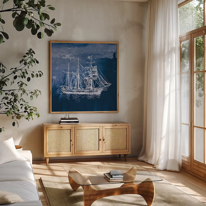 Sailing Ships III Indigo by Wild Apple Portfolio. Shown in a natural wood frame in a cozy modern living room. Available as an archival giclee rolled canvas, fine art paper, or poster print. SKU 32100a.