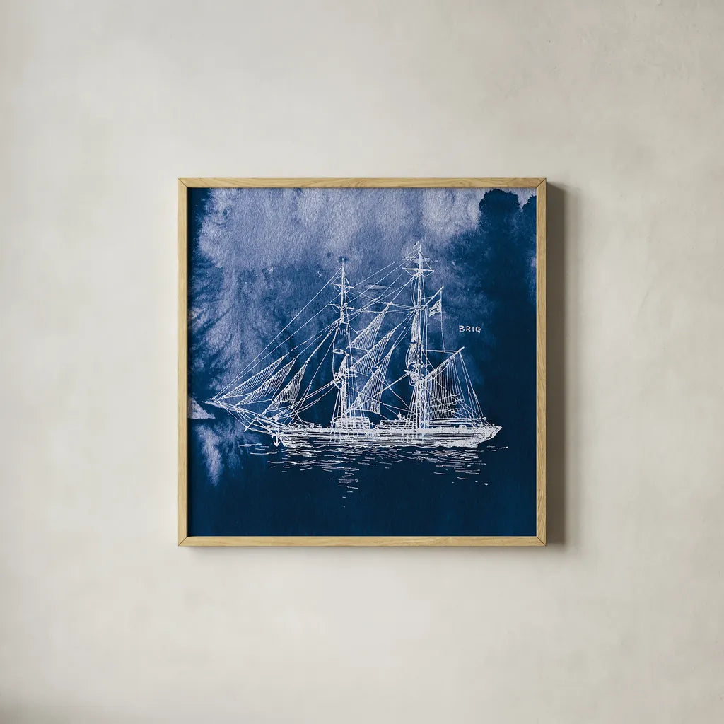 Sailing Ships IV Indigo by Wild Apple Portfolio. Shown in a natural wood glass frame for a timeless modern aesthetic. Available as an archival giclee rolled canvas, fine art paper, or poster print. SKU 32101a.