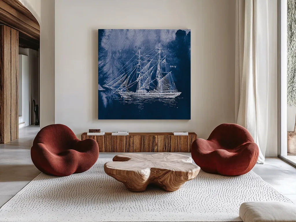 Sailing Ships IV Indigo by Wild Apple Portfolio. Shown as extra-large giant wall art in a modern living room. Available as an archival giclee rolled canvas, fine art paper, or poster print. SKU 32101a.