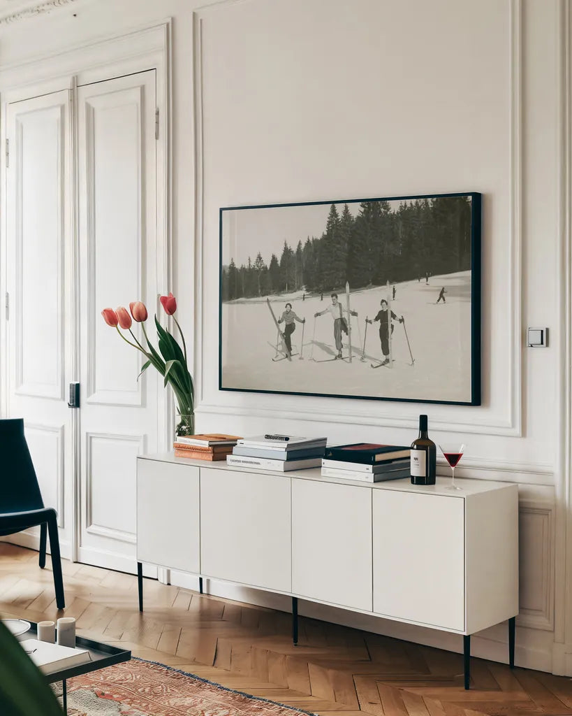 Ski Day by Wild Apple Portfolio. shown as a framed stretched canvas in a living room above a console. Available as a archival giclee rolled canvas, fine art paper, or poster print. SKU 75782i.