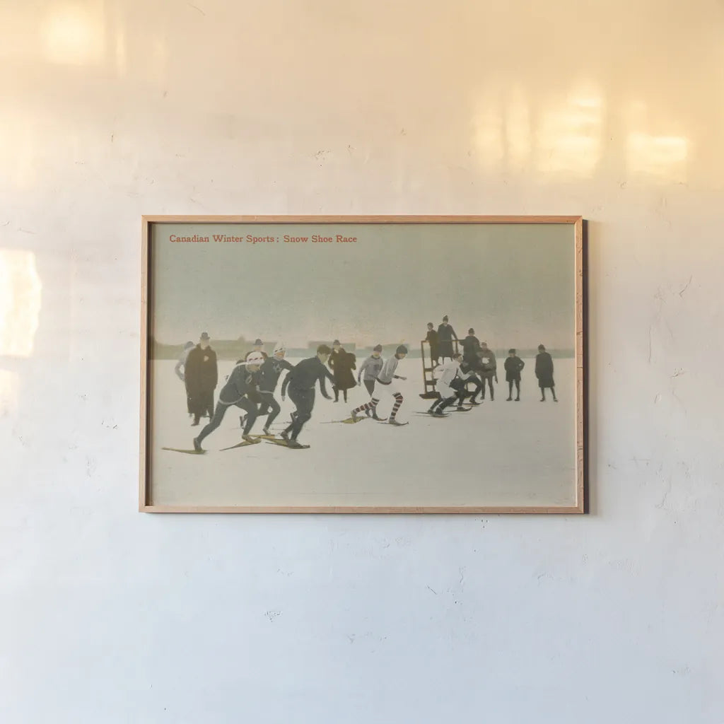 Snow Shoe Race by Wild Apple Portfolio. shown as a paper print in a natural frame. Available as a archival giclee rolled canvas, fine art paper, or poster print. SKU 70704i.
