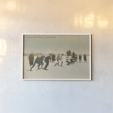 Snow Shoe Race by Wild Apple Portfolio. shown as a paper print in a white frame. Available as a archival giclee rolled canvas, fine art paper, or poster print. SKU 70704i.