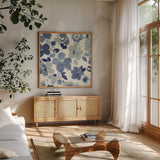 Soft Blue Florals III by Wild Apple Portfolio. Shown in a natural wood frame in a cozy modern living room. Available as an archival giclee rolled canvas, fine art paper, or poster print. SKU 56491a.