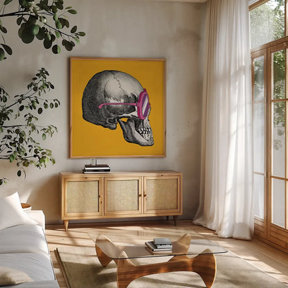 Sunny Skull I by Wild Apple Portfolio. Shown in a natural wood frame in a cozy modern living room. Available as an archival giclee rolled canvas, fine art paper, or poster print. SKU 21659a.