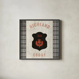 Tartan Lodge Shield I by Wild Apple Portfolio. Shown in a sleek black glass frame for a contemporary gallery look. Available as an archival giclee rolled canvas, fine art paper, or poster print. SKU 50336a.