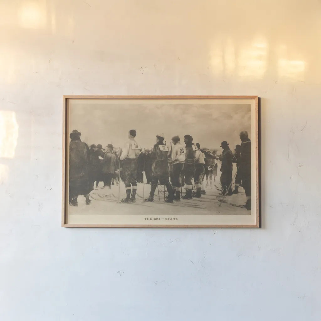 The Ski Start by Wild Apple Portfolio. shown as a paper print in a natural frame. Available as a archival giclee rolled canvas, fine art paper, or poster print. SKU 70706i.