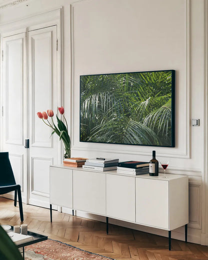 Tropical Fronds by Wild Apple Portfolio. shown as a framed stretched canvas in a living room above a console. Available as a archival giclee rolled canvas, fine art paper, or poster print. SKU 56308i.