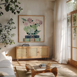 Blooming Books II by Yvette St. Amant. Shown in a natural wood frame in a cozy modern living room. Available as an archival giclee rolled canvas, fine art paper, or poster print. SKU 98057a.