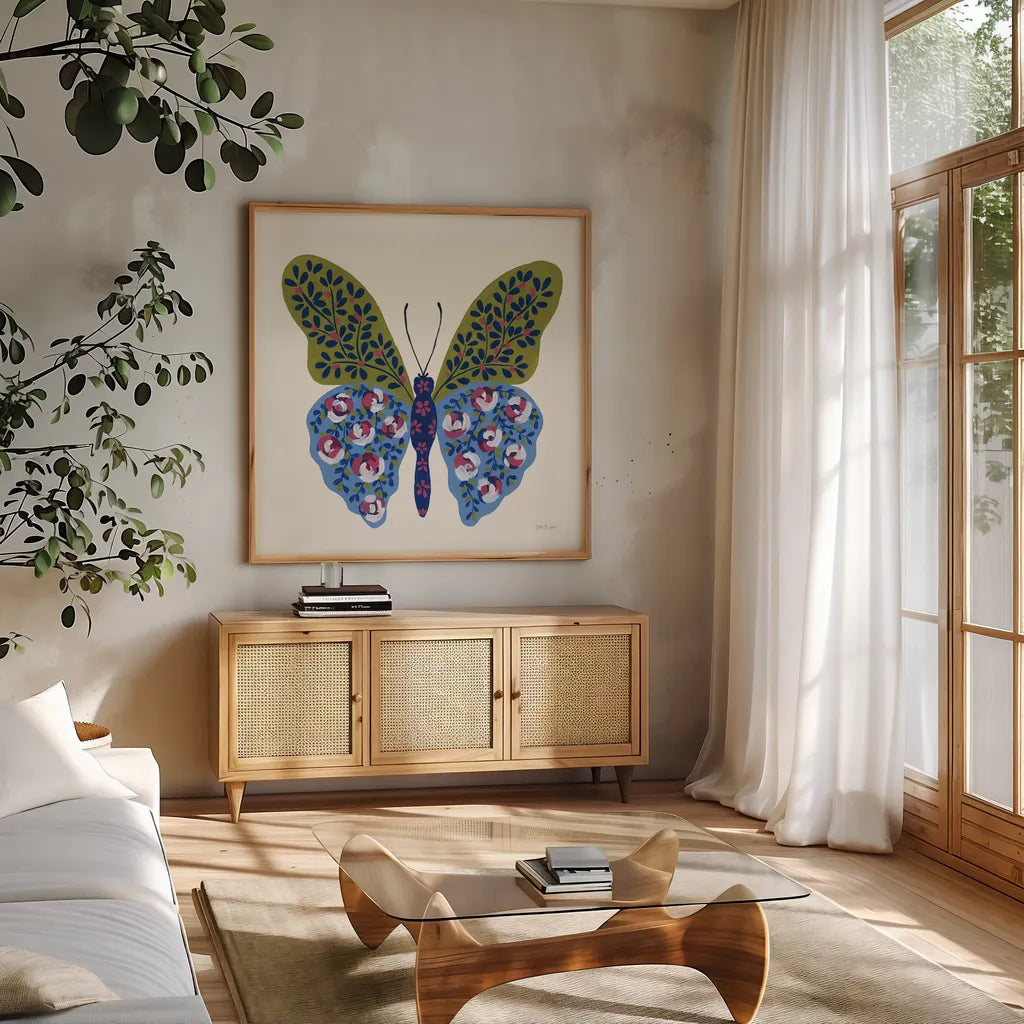 Blooming Butterfly I by Yvette St. Amant. Shown in a natural wood frame in a cozy modern living room. Available as an archival giclee rolled canvas, fine art paper, or poster print. SKU 91172a.