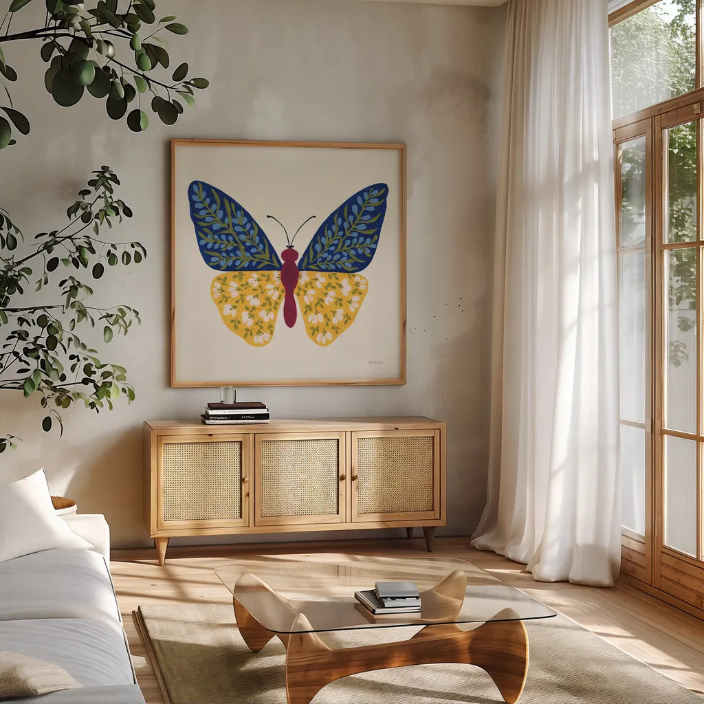 Blooming Butterfly III by Yvette St. Amant. Shown in a natural wood frame in a cozy modern living room. Available as an archival giclee rolled canvas, fine art paper, or poster print. SKU 91174a.
