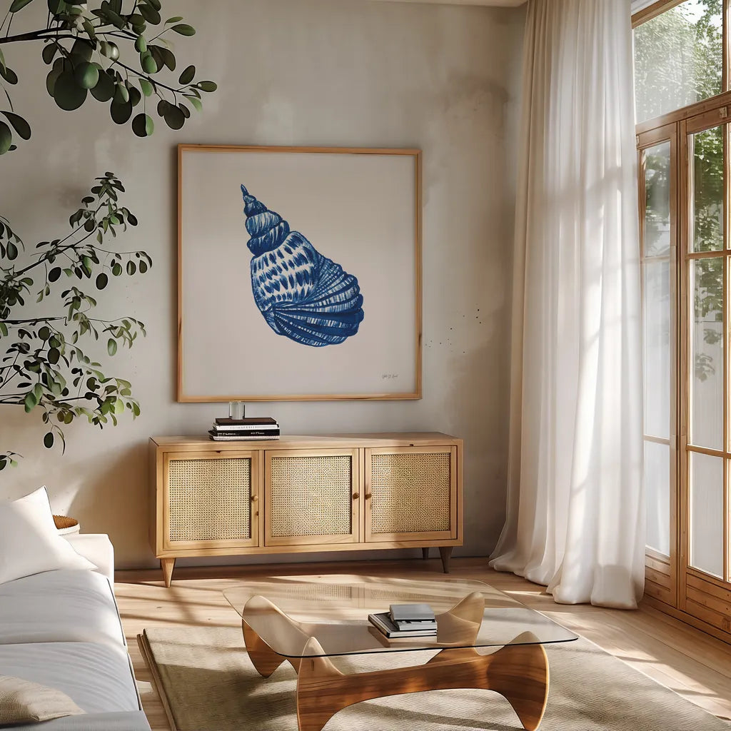 Blue Shell II by Yvette St. Amant. Shown in a natural wood frame in a cozy modern living room. Available as an archival giclee rolled canvas, fine art paper, or poster print. SKU 101198a.