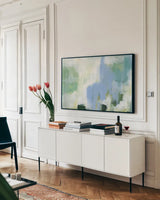 Blue Vibration by Yvette St. Amant. shown as a framed stretched canvas in a living room above a console. Available as a archival giclee rolled canvas, fine art paper, or poster print. SKU 99866i.