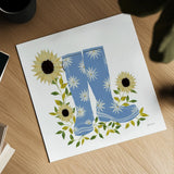Boots with Sunflowers by Yvette St. Amant. Shown as a detailed flat fine art print, highlighting archival giclee quality. Available as an archival giclee rolled canvas, fine art paper, or poster print. SKU 101177a.