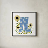 Boots with Sunflowers by Yvette St. Amant. Shown in a sleek black glass frame for a contemporary gallery look. Available as an archival giclee rolled canvas, fine art paper, or poster print. SKU 101177a.