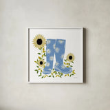 Boots with Sunflowers by Yvette St. Amant. Shown in a crisp white glass frame for a clean and minimalist style. Available as an archival giclee rolled canvas, fine art paper, or poster print. SKU 101177a.