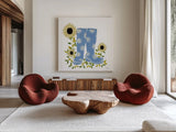 Boots with Sunflowers by Yvette St. Amant. Shown as extra-large giant wall art in a modern living room. Available as an archival giclee rolled canvas, fine art paper, or poster print. SKU 101177a.