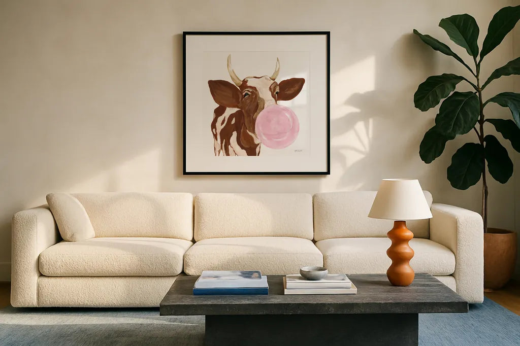 Bubblegum Cow by Yvette St. Amant. Displayed in a glass frame with matte in a clean modern living room. Available as an archival giclee rolled canvas, fine art paper, or poster print. SKU 91464a.