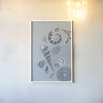 Coastal Shells I by Yvette St. Amant. shown as a paper print in a white frame. Available as a archival giclee rolled canvas, fine art paper, or poster print. SKU 88368h.