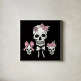 Coquette Skulls by Yvette St. Amant. Shown in a sleek black glass frame for a contemporary gallery look. Available as an archival giclee rolled canvas, fine art paper, or poster print. SKU 94021a.