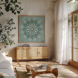 Desert Mandala Green by Yvette St. Amant. Shown in a natural wood frame in a cozy modern living room. Available as an archival giclee rolled canvas, fine art paper, or poster print. SKU 91001a.