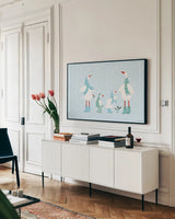 Ducks in the Snow I by Yvette St. Amant. shown as a framed stretched canvas in a living room above a console. Available as a archival giclee rolled canvas, fine art paper, or poster print. SKU 97314i.