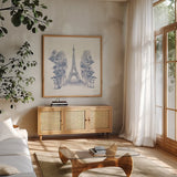 Eiffel Tower by Yvette St. Amant. Shown in a natural wood frame in a cozy modern living room. Available as an archival giclee rolled canvas, fine art paper, or poster print. SKU 91413a.