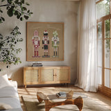 Festive Nutcrackers I by Yvette St. Amant. Shown in a natural wood frame in a cozy modern living room. Available as an archival giclee rolled canvas, fine art paper, or poster print. SKU 89869a.