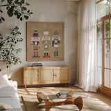 Festive Nutcrackers II by Yvette St. Amant. Shown in a natural wood frame in a cozy modern living room. Available as an archival giclee rolled canvas, fine art paper, or poster print. SKU 89870a.