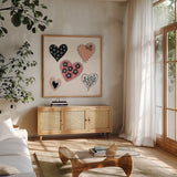 Floral Hearts by Yvette St. Amant. Shown in a natural wood frame in a cozy modern living room. Available as an archival giclee rolled canvas, fine art paper, or poster print. SKU 94015a.