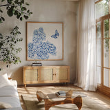 Flutter with Charm III by Yvette St. Amant. Shown in a natural wood frame in a cozy modern living room. Available as an archival giclee rolled canvas, fine art paper, or poster print. SKU 99016a.